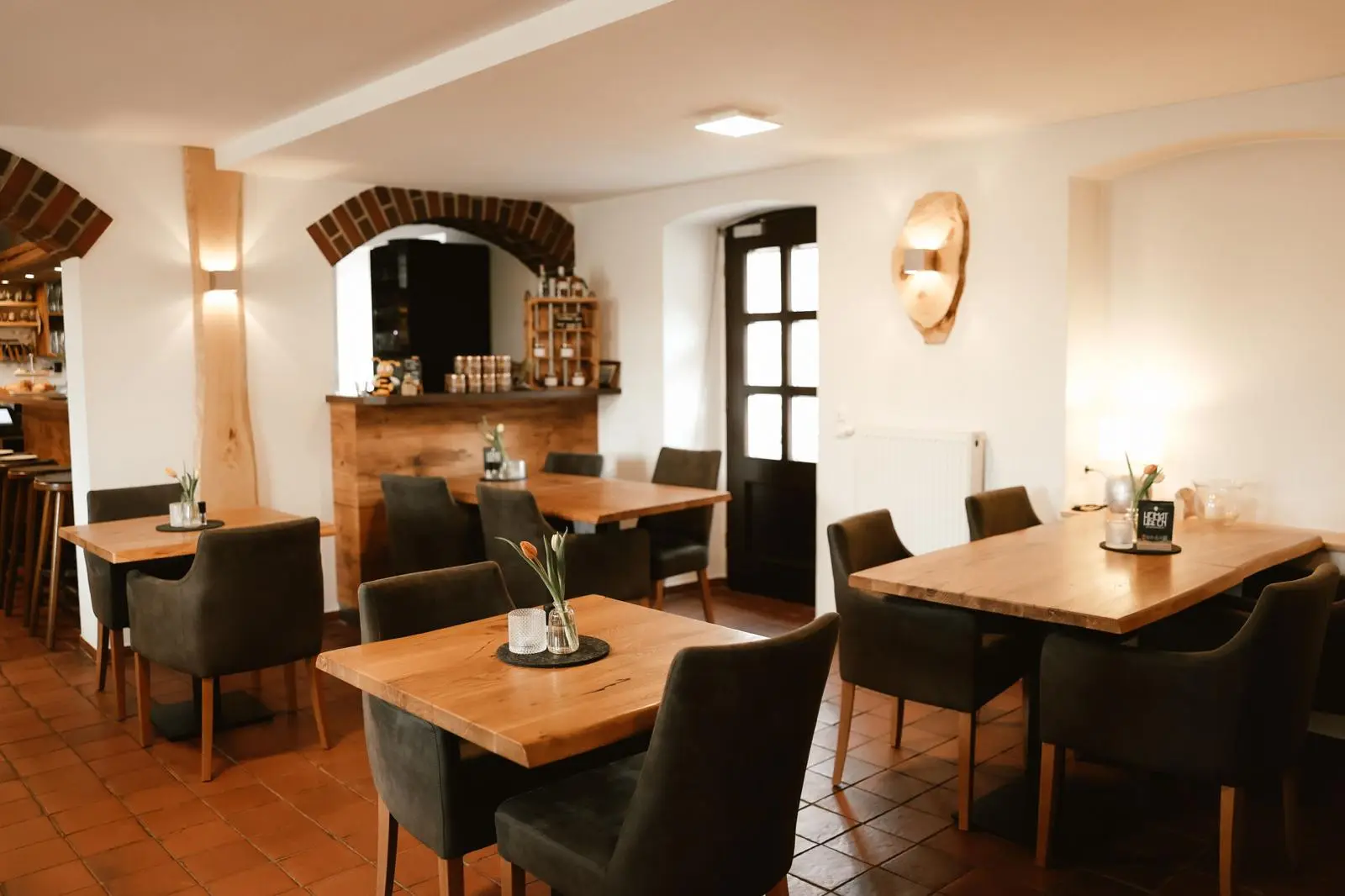 Dining room with solid wood tables and a view of the bar