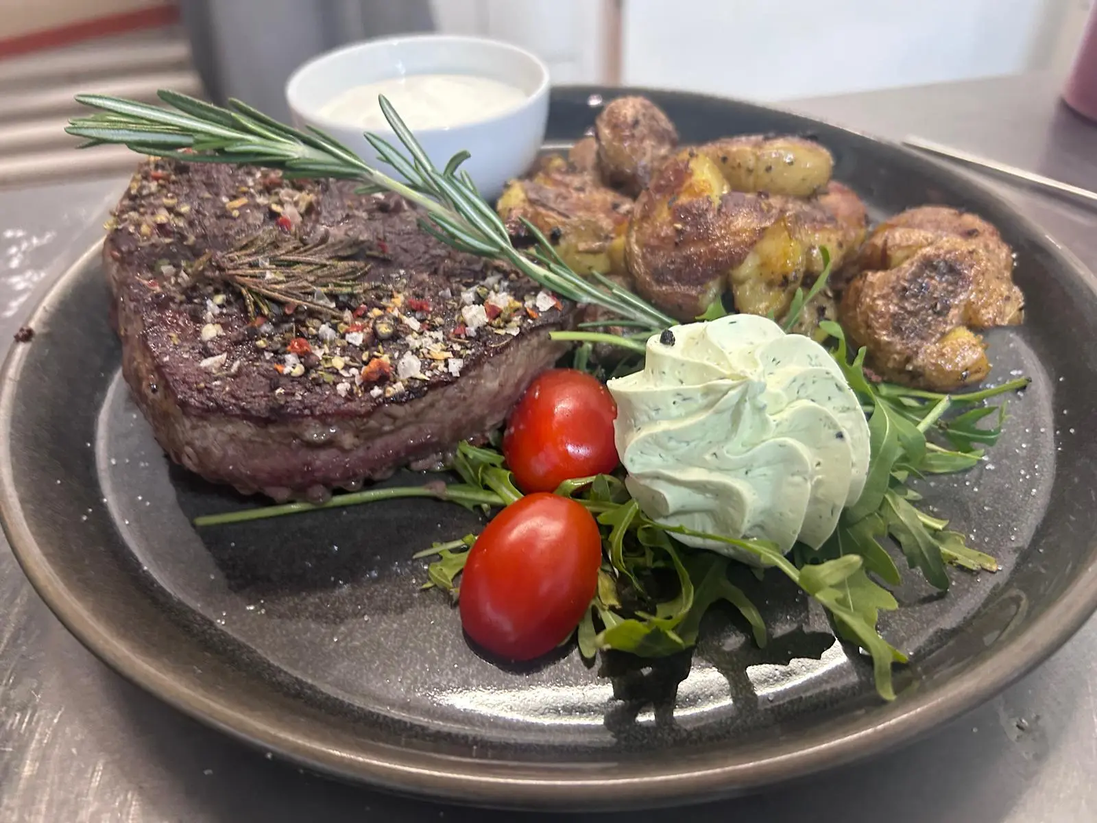 Steak with rosemary, fried potatoes and herb butter